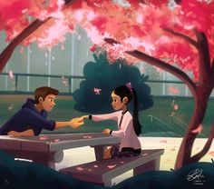 a man and woman sitting at a picnic table in front of trees with pink flowers