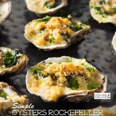 some oysters with cheese and greens on them are ready to be served in the oven