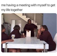 a group of people sitting around a white table