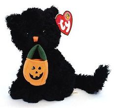 a black teddy bear with a jack - o'- lantern on its nose and mouth