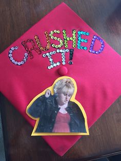 a pink graduation cap with the words, oh she's out and an image of a woman on it