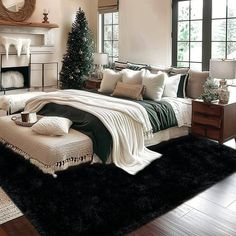 a bedroom decorated for christmas with black and white decor on the bed, fireplace and windows