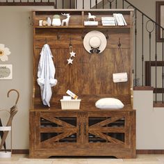 a wooden cabinet sitting in the middle of a living room next to a stair case