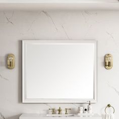 a bathroom vanity with two sinks and a large mirror on the wall above it,