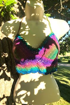 Summery hand-crocheted festival halter top in cool rainbow shades, ready to ship!  Just made for concerts, festivals, the beach, and anywhere else a pretty boho/hippie/vintage-vibe top belongs!  Made of a soft acrylic-blend yarn with a matching blue glitter thread for extra sparkle!  Created in a smoke-free home.  Each top is a unique work of art--this listing is for the one pictured.    Pattern is "The Bea" by the talented girliescrochet.com Measurements  -  One size fits most.  Crochet stretches a bit.  Tops fit like an apron with back mostly bare, so long ties allow them to adjust to a range of sizes.   Variations in size between tops mostly due to differences in yarn thickness used.   Cups: 5" wide/6" high Underbust band:  21" Tie straps:  16" each Height (top of cup to lower edge):  9 Affordable Multicolor Bohemian Halter Top, Sparkle Rave Outfit, Bohemian Multicolor Halter Neck Crop Top, Multicolor Hippie Halter Top For Vacation, Hippie Multicolor Halter Top For Vacation, Multicolor Triangle Halter Top For Festival, Multicolor Halter Neck Crop Top For Festival, Hippie Triangle Halter Top For Festivals, Multicolor Summer Halter Top For Festival