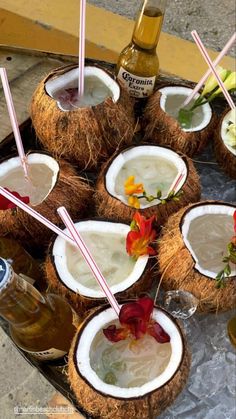 there are many coconuts with drinks in them