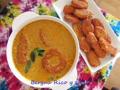 there is a bowl of soup and some fried shrimp