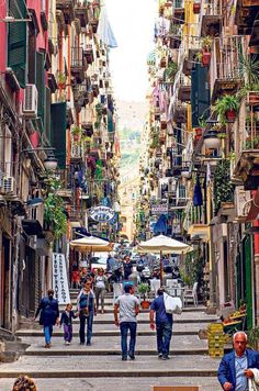 people are walking down the stairs in an alley way