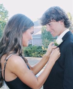 a young man and woman standing next to each other