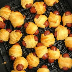 an air fryer filled with pigs in a blanket