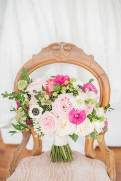 a bouquet of flowers sitting on top of a wooden chair