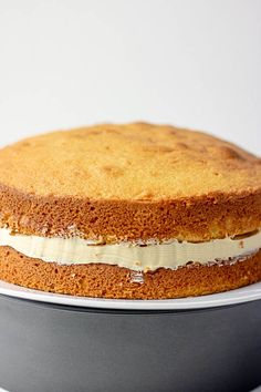 a cake sitting on top of a pan covered in frosting