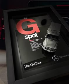 an advertisement for the mercedes g - class is displayed in a black frame with red lettering