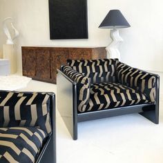 a black and white couch sitting next to a lamp