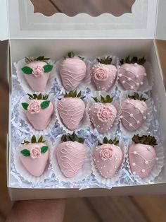 a box filled with pink chocolate covered strawberries