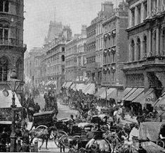 an old black and white photo of horse drawn carriages on a city street with tall buildings in the background