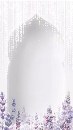 lavender flowers are in the foreground and a white background with beads hanging from it