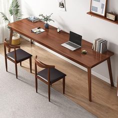 a wooden table with two chairs and a laptop on it