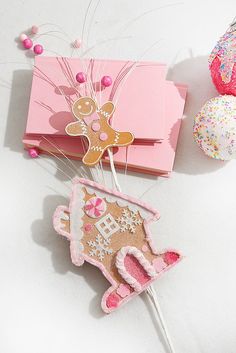 a pink box with a ginger on it next to some cookies and sprinkles