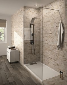 an image of a bathroom with tile on the walls and floor, including a walk in shower