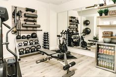 a home gym with exercise equipment and mirrors