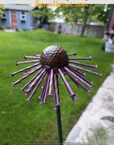 a purple sunflower made out of pencils in the grass with text overlay