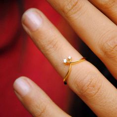 a woman's hand with a diamond ring on it