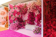 a room with flowers on the walls and pink carpeted flooring, all in different colors