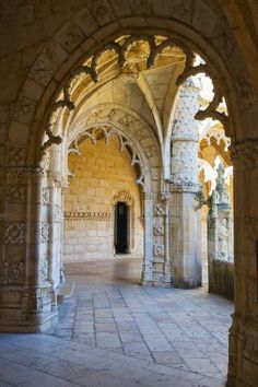 an arch in the middle of a building with stone floors and arches on both sides