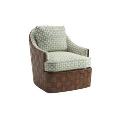 a chair that is sitting in front of a white wall with a green and blue pattern on it