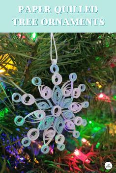 a paper quilled ornament hanging from a christmas tree with text overlay