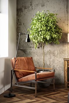 a brown chair sitting next to a potted plant