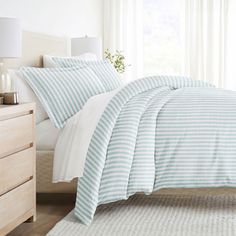 a bed with blue and white striped sheets