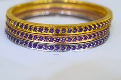 Metal: 14kt Yellow, White And Rose Gold Weight Of Bangle Including Gems: 31 grams Stone: Amethyst Stone Shape: Round Amethyst Weight: 4.86 ctw Closer Type: Slip On Width Of Bangle: 4.800mm Inside Circumference Of Bangle: Approximately 2 1/2 inches fits a 7 1/2 wrist. If you need a different size please inquire. Customizable: Yes, we can make these bangles in any color metal with any gems. Variations Listed: Pink Sapphire- https://www.etsy.com/listing/662539224/14k-rose-gold-pink-sapphire-bangle? Purple Gemstone Bangle For Formal Occasions, Formal Purple Gemstone Bangle, Sapphire Bangle, Amethyst Bangle, Gold Skies, Amethyst And Diamond Ring, Rose Gold Pink, Gold Dipped, Matching Band