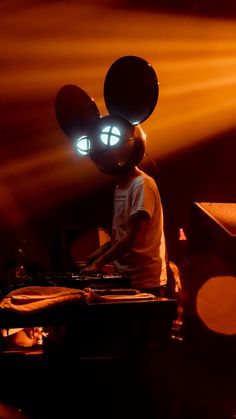 a person with glowing eyes and headphones playing music on a turntable in the dark