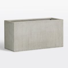 a concrete planter sitting on top of a white floor