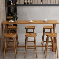 a wooden table with four stools in front of it