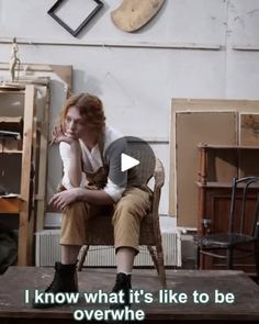 a woman sitting on top of a wooden chair