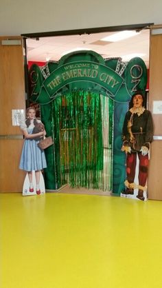 two children are standing in front of the entrance to the wizard's city theatre