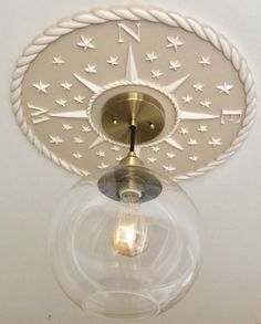 the light fixture is hanging from the ceiling with stars on it's roped design