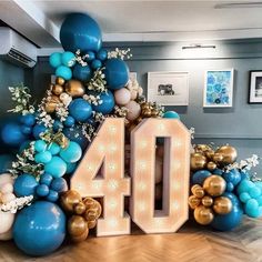 the number 40 is surrounded by balloons and streamers in blue, gold and white