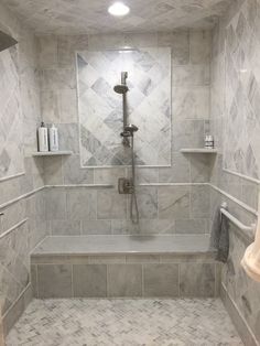 a walk in shower sitting next to a white sink