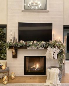 a living room with a fireplace decorated for christmas