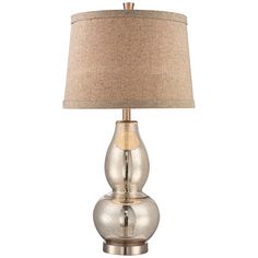 a silver lamp with a beige shade on it's base and a light brown fabric shade