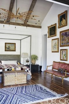 a bedroom with white walls and wooden floors