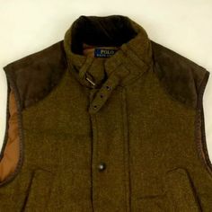 Large Ralph Lauren Polo Wool Winter Vest. 100% Down & Feather Filling, 100% Cotton Collar And Pocket Flaps, And 100% Polyester Lining. Has Four Front Pockets And One Inner Pocket On The Left Side. Leather Shoulder Embellishments And Full Zip Down The Front With Buttons For Added Warmth. Collar Buckles And Pockets Are Lined. In Excellent Condition With Functional Buttons And Zippers. Luxury Winter Vest For Workwear, Luxury Vest For Fall Workwear, Luxury Winter Workwear Vest, Classic Outdoor Vest For Fall, Classic Brown Vest For Winter, Vintage Brown Outerwear For Layering, Polo Ralph Lauren Vest, Ralph Lauren Vest, Hunting Jacket