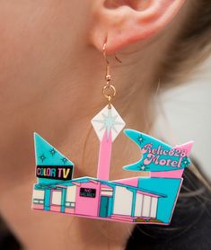 Indulge in a nostalgic trip down memory lane with these 70s Retro Relic828 Kitschy Motel Earrings. Inspired by the quirky and colorful motels of the era, these earrings feature a unique design that captures the retro charm of the 70s. Crafted from lightweight acrylic, these earrings offer comfort without compromising on style. The hooks are made of stainless steel, coated in 18k gold for a touch of luxury, and are nickel-free to ensure a comfortable wearing experience. Product Details: Size: Eac Retro Multicolor Nickel-free Jewelry, Retro Multicolor Drop Earrings, Retro Dangle Jewelry, Multicolor Nickel-free Retro Jewelry, Retro Dangle Earrings, Retro Pink Nickel-free Jewelry, 70s Nostalgia, Retro Earrings, Retro Earring