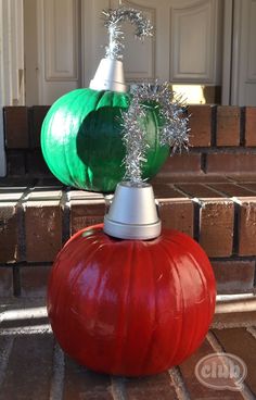 a red and green pumpkin sitting on top of a brick floor next to a white door