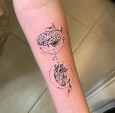 a person with a tattoo on their arm that has a heart and brain in it