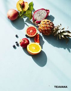 various fruits are arranged on a blue surface